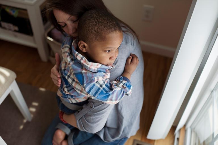 Woman hugging a child who appears to be upset