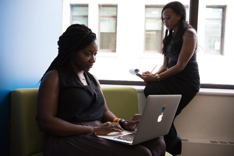 woman in office typing on a laptop