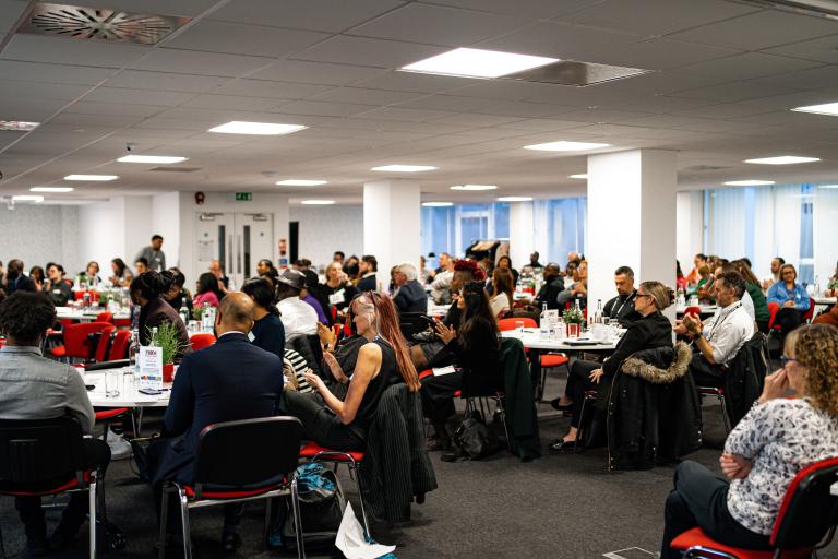 large room with people seated around tables